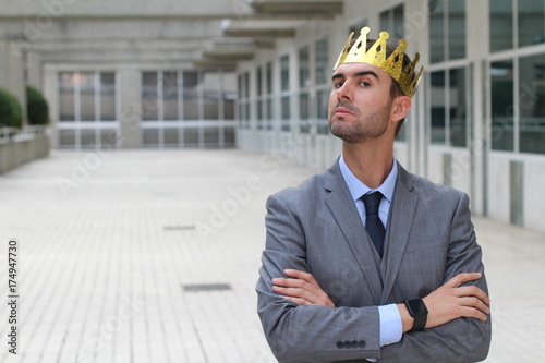 Obraz na plátně Arrogant businessman with a crown in office space