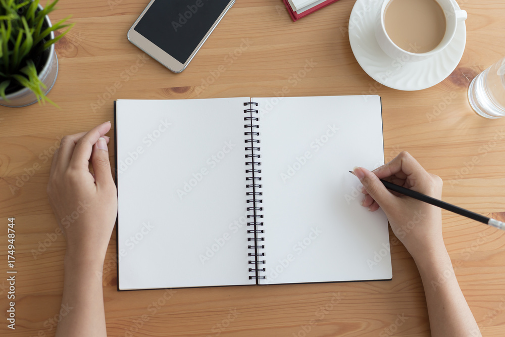 Businessman hands working with blank paper and pencils on wooden table Businessman hands working with blank paper and pencils on wooden table
