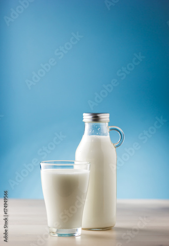 Jar and glass of milk, front view
