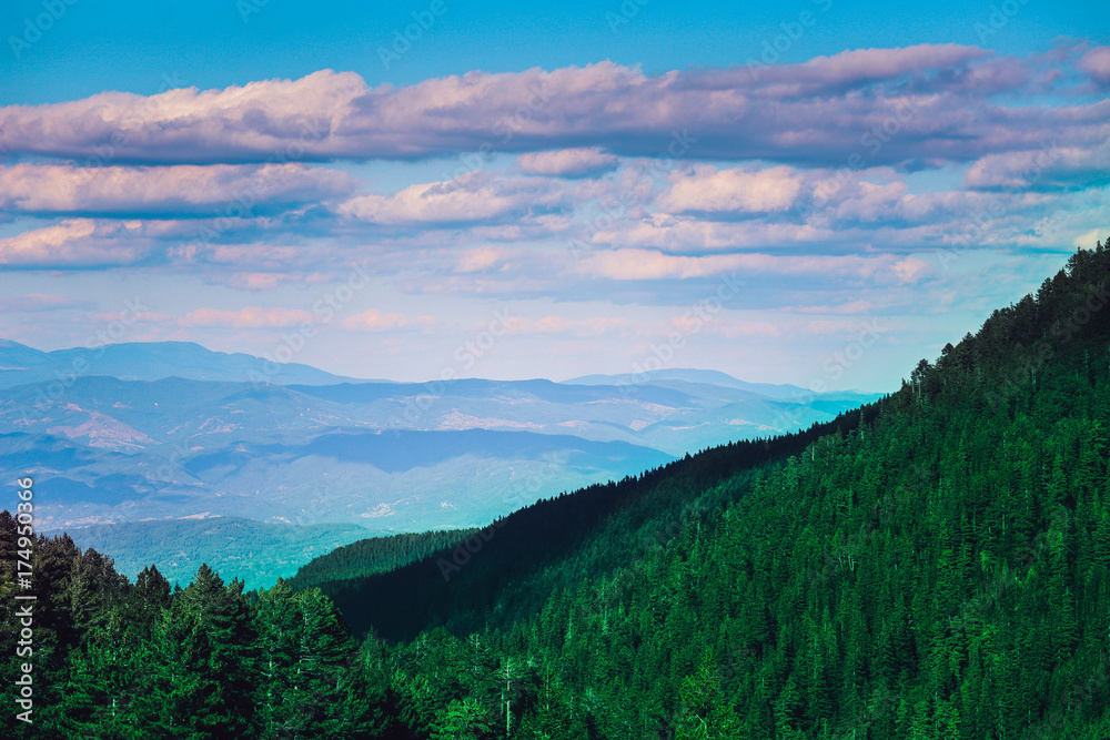 Obraz premium Beautiful view on the high green mountains peaks, on the blue sky background. Alpine Mountain hiking paradise landscape, no people.