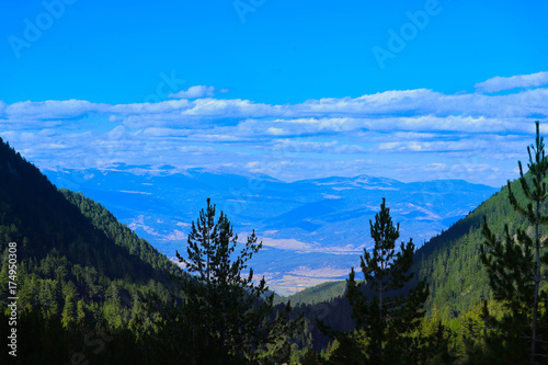 Beautiful view on the high green mountains peaks, on the blue sky background. Alpine Mountain hiking paradise landscape, no people. photo