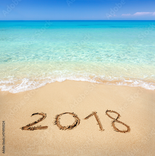 2018 written on sandy beach