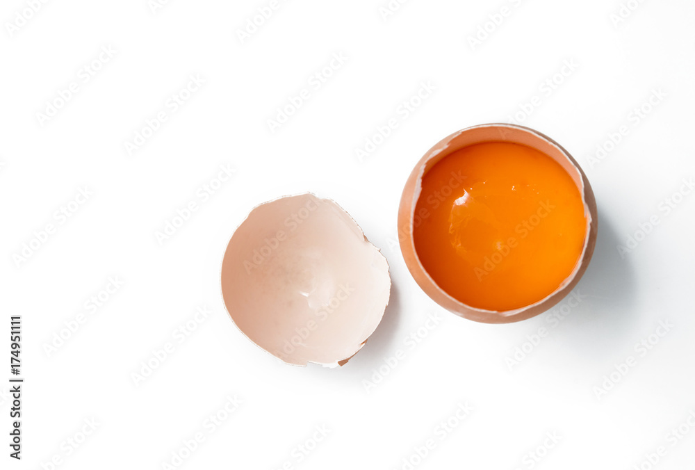 egg yolk in egg shell, cracked egg white isolated on white background - obrazy, fototapety, plakaty 