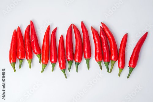 row of red pepper isolated on white background
