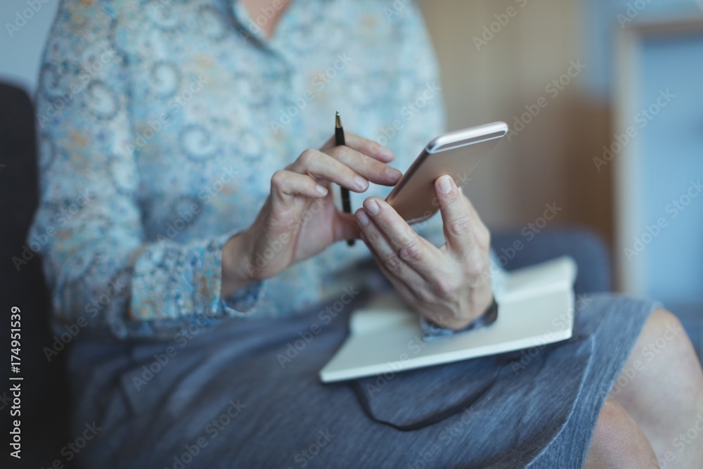 Midsection of businesswoman using phone Midsection of businesswoman using phone
