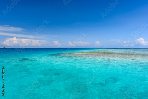 Colorful photo of Maldives atolls and deep blue sea © 9mot