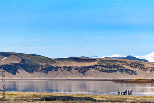 Group of photographer taking photo of beautiful reflection of mountain near Vik, iceland