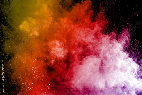 Explosion of multicolored dust on black background. © Chaiwat