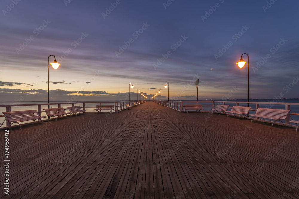 Beautiful sunrise over a wooden pier in Gdynia, Poland Beautiful sunrise over a wooden pier in Gdynia, Poland