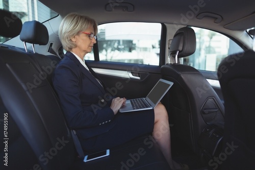 Businesswoman using laptop in car © wavebreak3