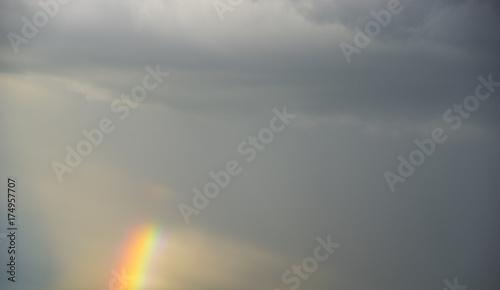 stormy sky with colorful rainbow