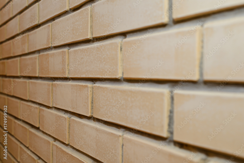 beige brick wall at an angle from the side beige brick wall at an angle from the side