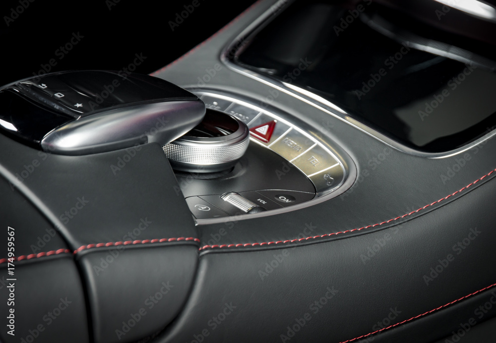 Media and navigation control buttons of a Modern car. Car interior details. White leather interior of the luxury modern car. Modern car interior