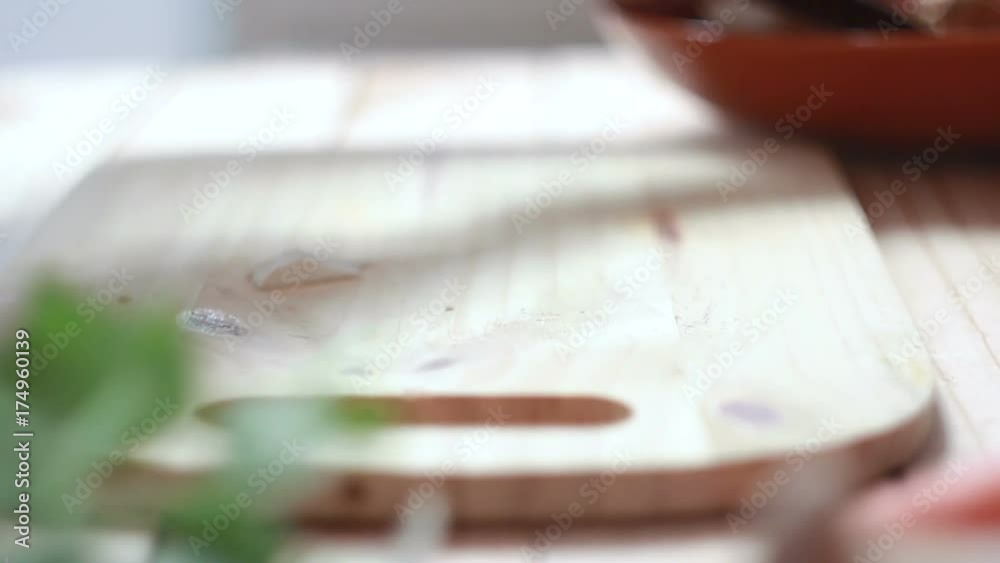 Close up shot hands of woman using kitchen knife slide cut Eringi mushroom on wooden cutting board preparing for cooking Close up shot hands of woman using kitchen knife slide cut Eringi mushroom on wooden cutting board preparing for cooking