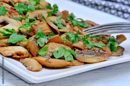 Mushroom in a plate with fork on table