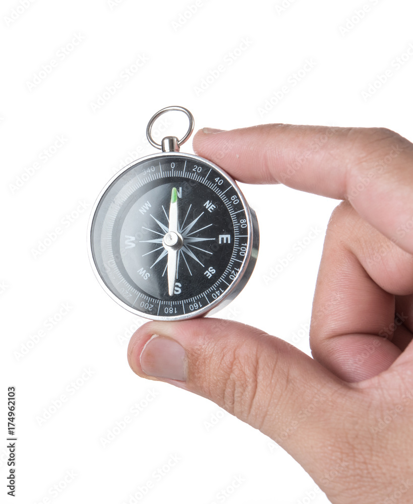 Hand holding black compass isolated on white background Hand holding black compass isolated on white background