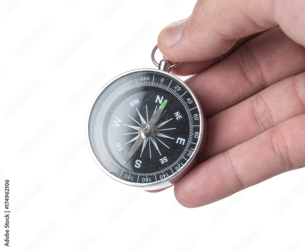 Hand holding black compass isolated on white background Hand holding black compass isolated on white background