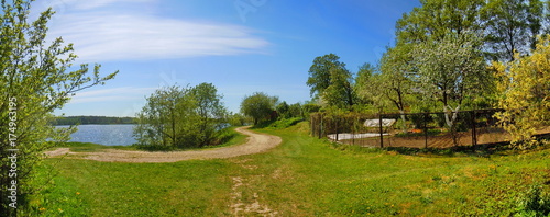 Panoramic view of unpaved road along the river