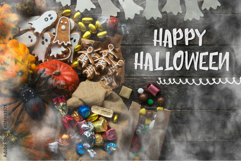 Naklejka premium Funny delicious ginger biscuits for Halloween shape ghost and skeleton with pumpkins and sweets. holiday text 