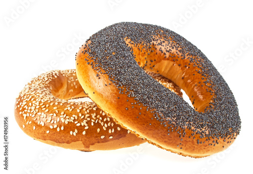 Tasty bagels with sesame and poppy seeds on a white background