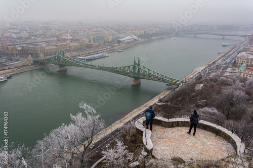 Photography Scenic view of Liberty Bridge from Gellert Hill in a snowy winter day, Budapest