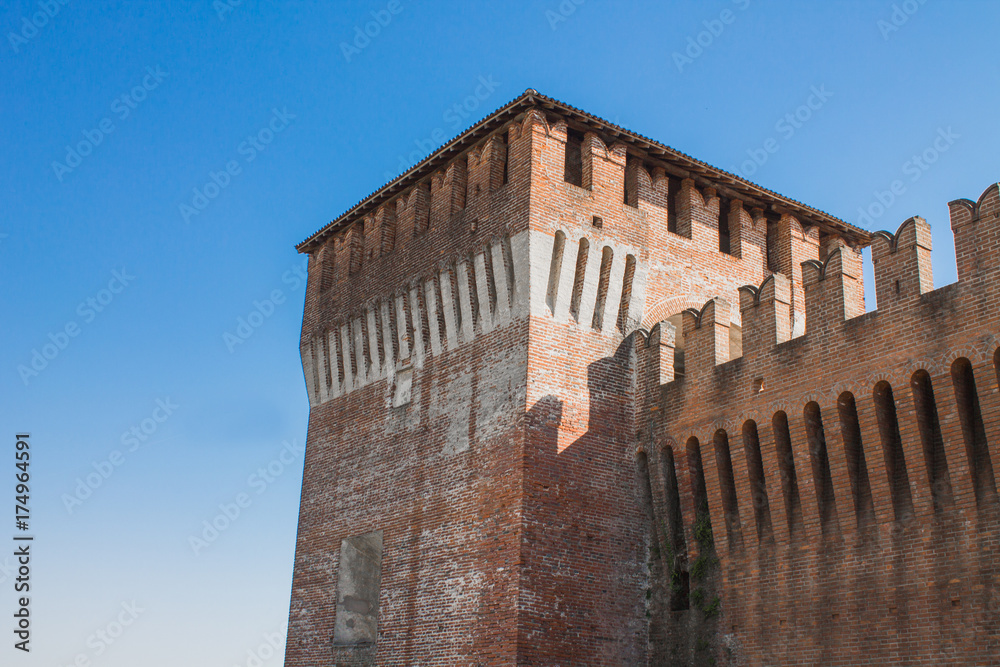 Medieval castle tower angle on light blue sky