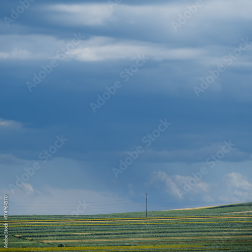 Cultivated countryside with cloudy sky