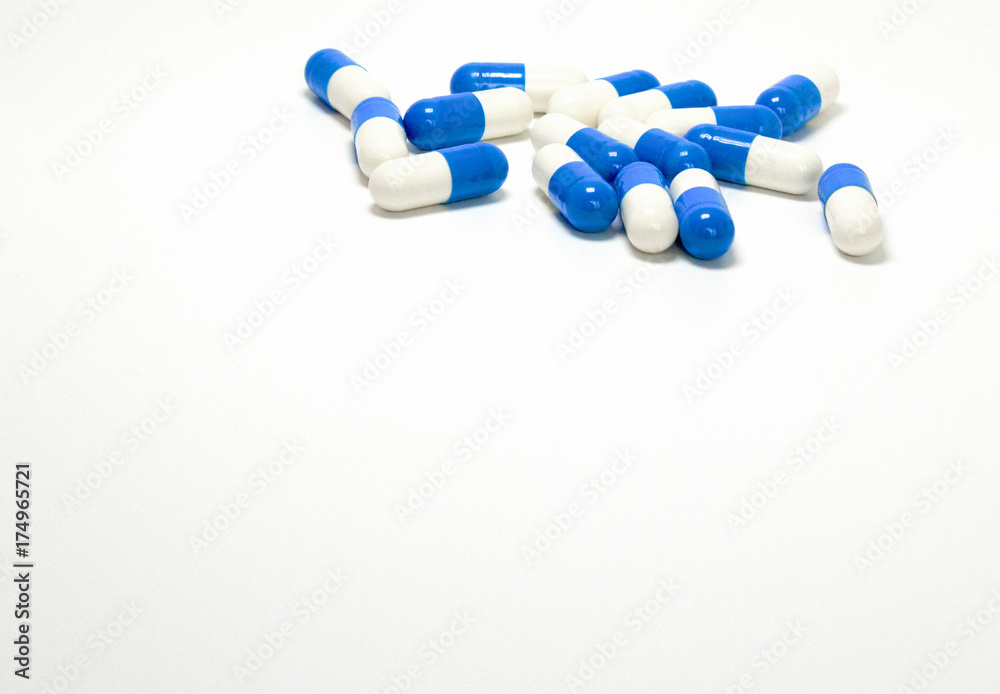 Background of blue and white isolated pharmaceutical capsules. Medication concept.