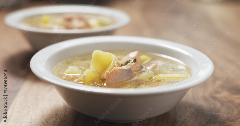 closeup fish soup with salmon on wood table closeup fish soup with salmon on wood table