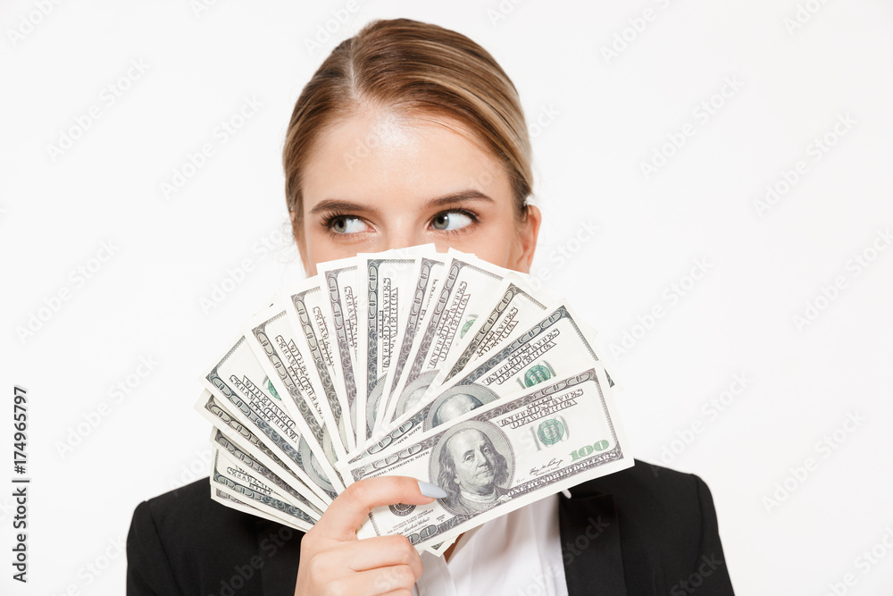 Pretty blonde business woman hiding behing the money Pretty blonde business woman hiding behing the money