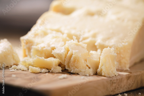pieces of hard parmesan cheese on olive board