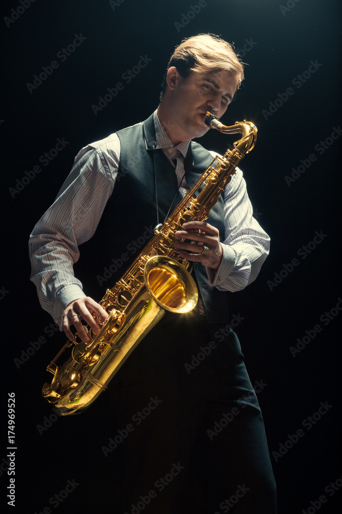 Naklejka premium Young man playing the Saxophone
