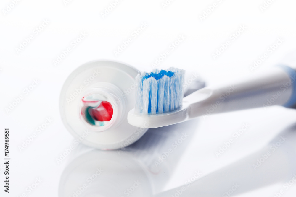 Dental brush and tube with paste isolated on white