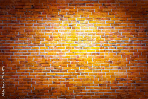 Vintage brick wall background with spotlight on the wall