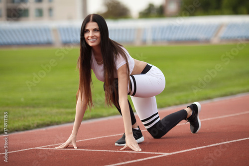 young fitness woman runner running on stadium track