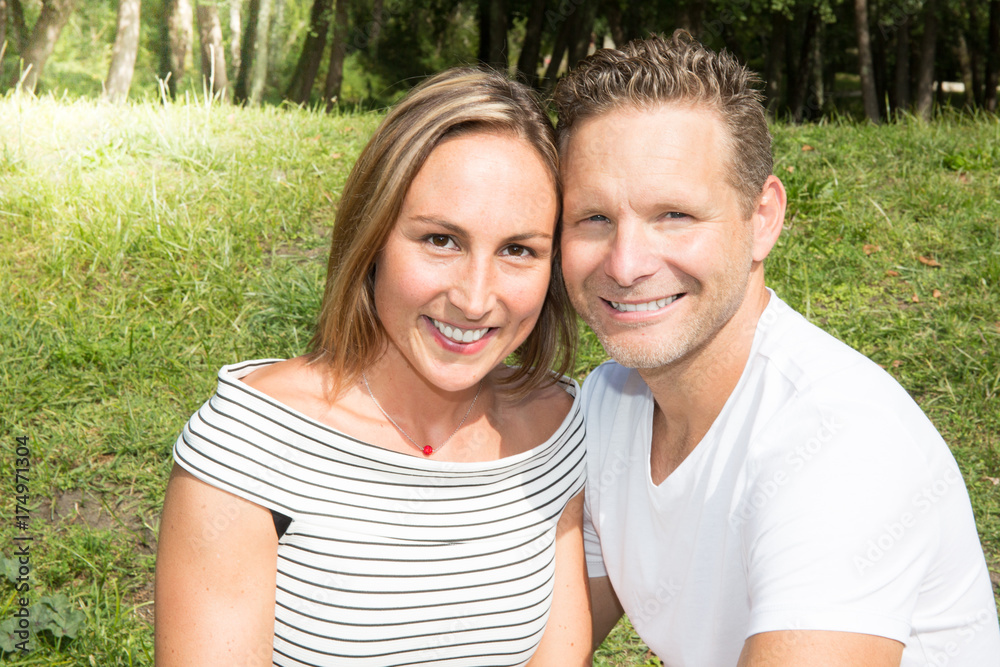 Close up face portrait of young couple in love in green park garden