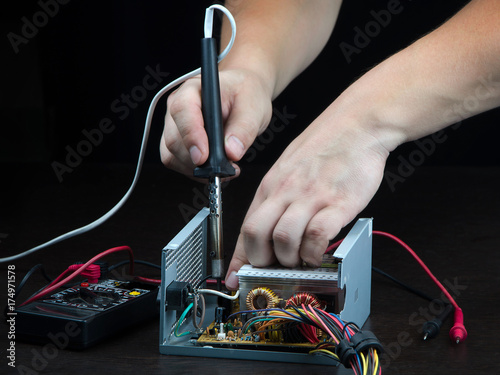 Repair of electronics with a soldering iron.