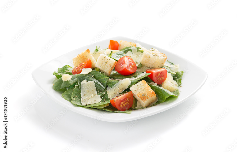 caesar salad in plate on white background