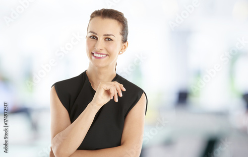 Smiling young female. Casual businesswoman standing at the office.  © gzorgz