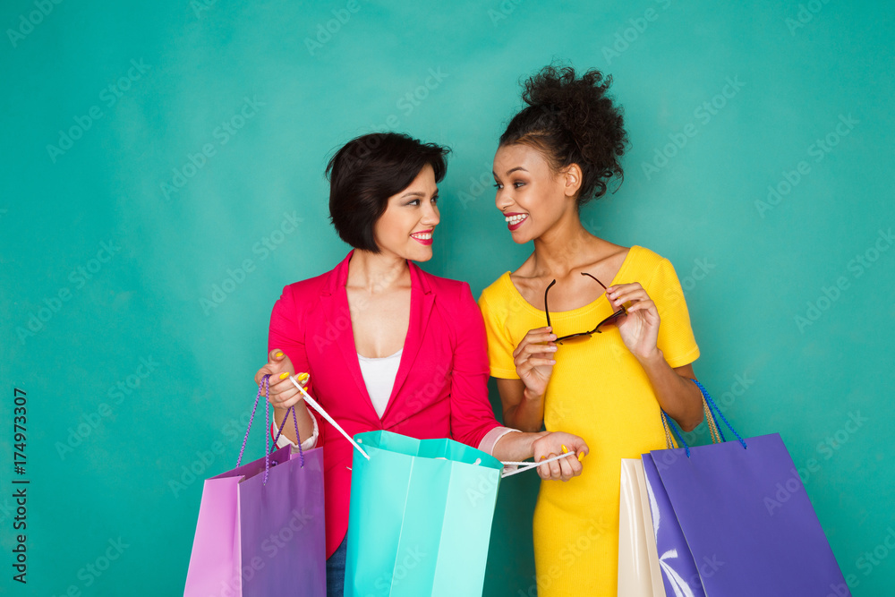 Excited multiethnic girls with shopping bags Excited multiethnic girls with shopping bags