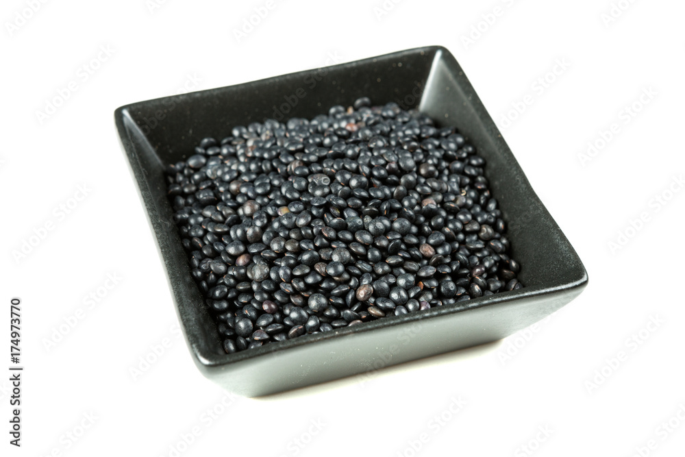 Black beluga lentils isolated on a white background Black beluga lentils isolated on a white background