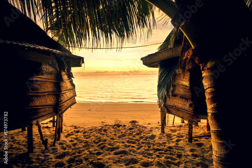 samoa bungalow fale on beach during sunrise and lowtide photo