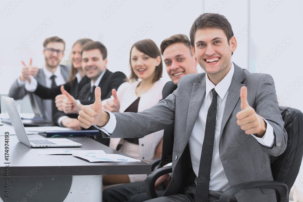 successful business team showing thumbs up successful business team showing thumbs up