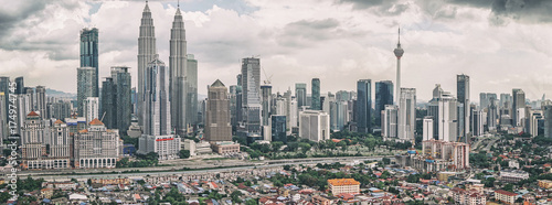 Panoramic view of Kuala Lumpur skyline with Petronas Twin Towers and other corporate buildings