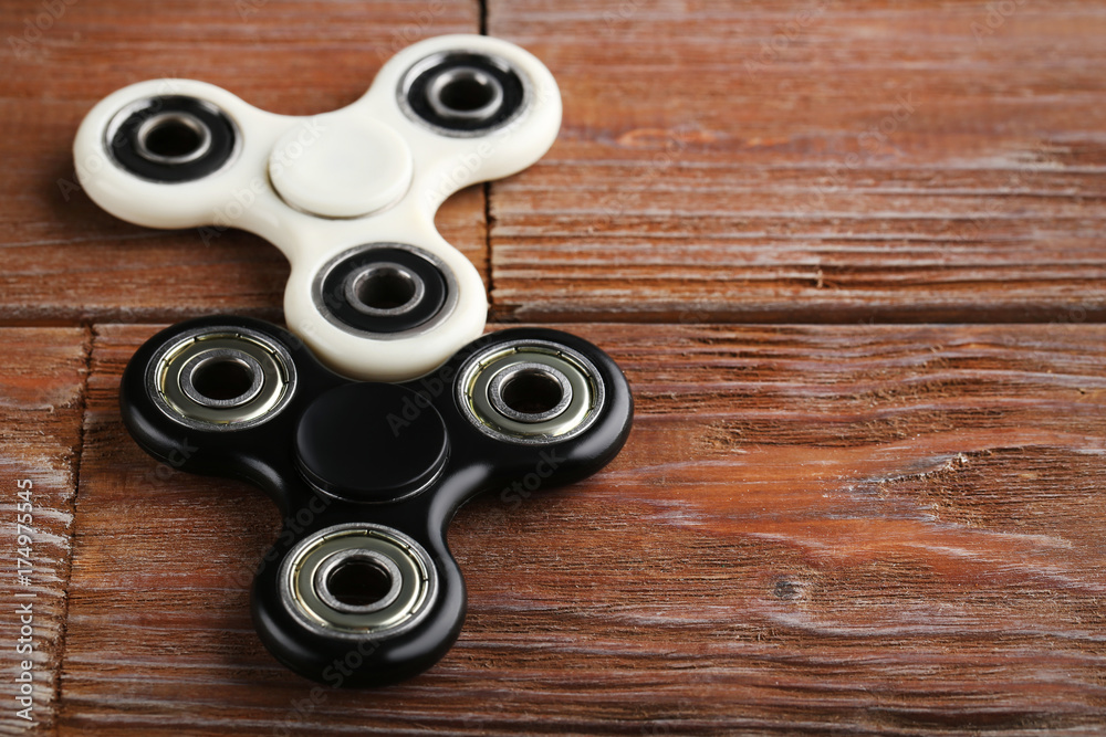 Fidget spinner toys on brown wooden table