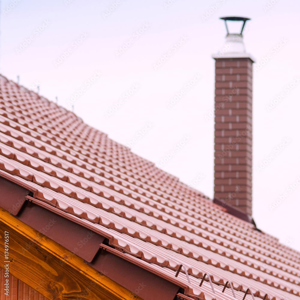 Naklejka premium new house with orange brick wall, roof and chimney. House building worker concept.