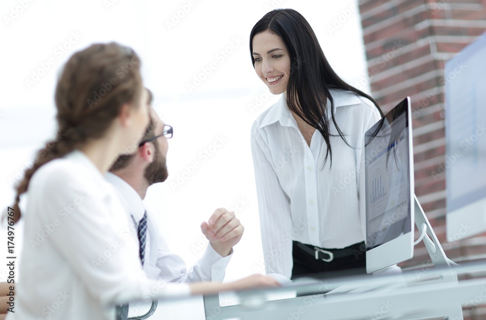 young business woman talking to colleagues in the office young business woman talking to colleagues in the office