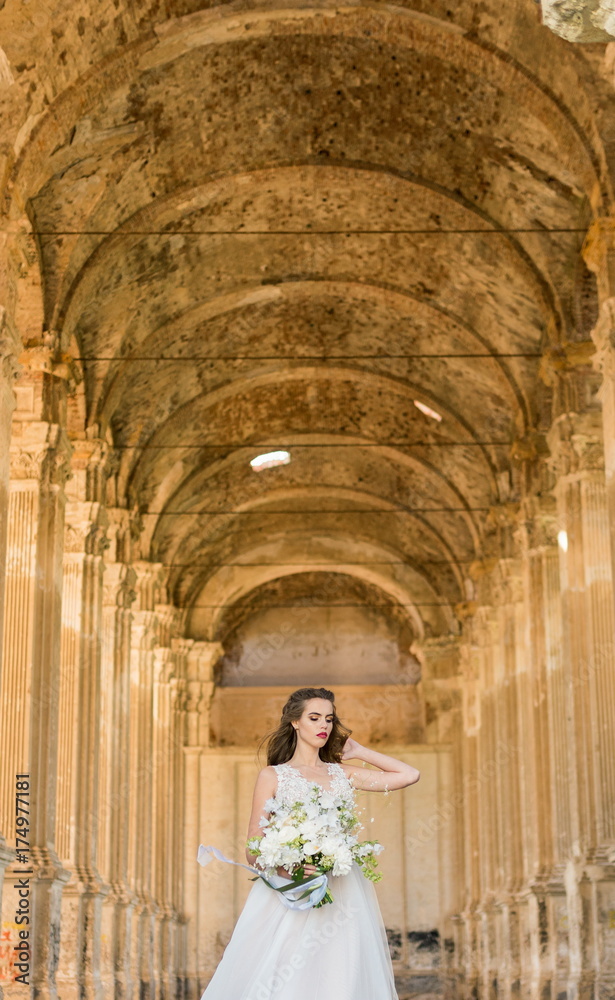Romantic beautiful bride in luxury dress posing of beautiful architecture Romantic beautiful bride in luxury dress posing of beautiful architecture