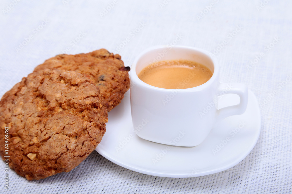 Classic espresso in white cup with cake on white background. Classic espresso in white cup with cake on white background.