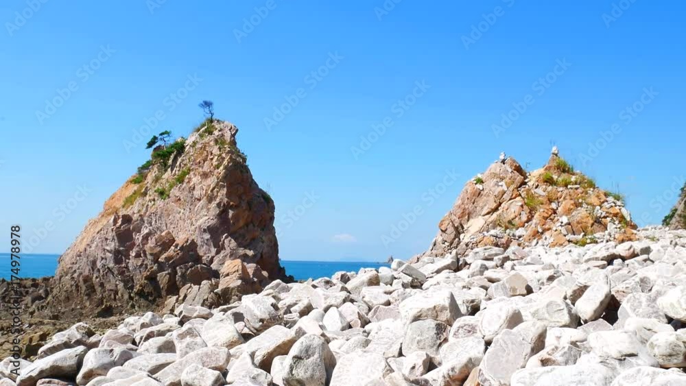 Rock Island: The lofty pine tree of the seashore of many rocks. Slider shot. Rock Island: The lofty pine tree of the seashore of many rocks. Slider shot.